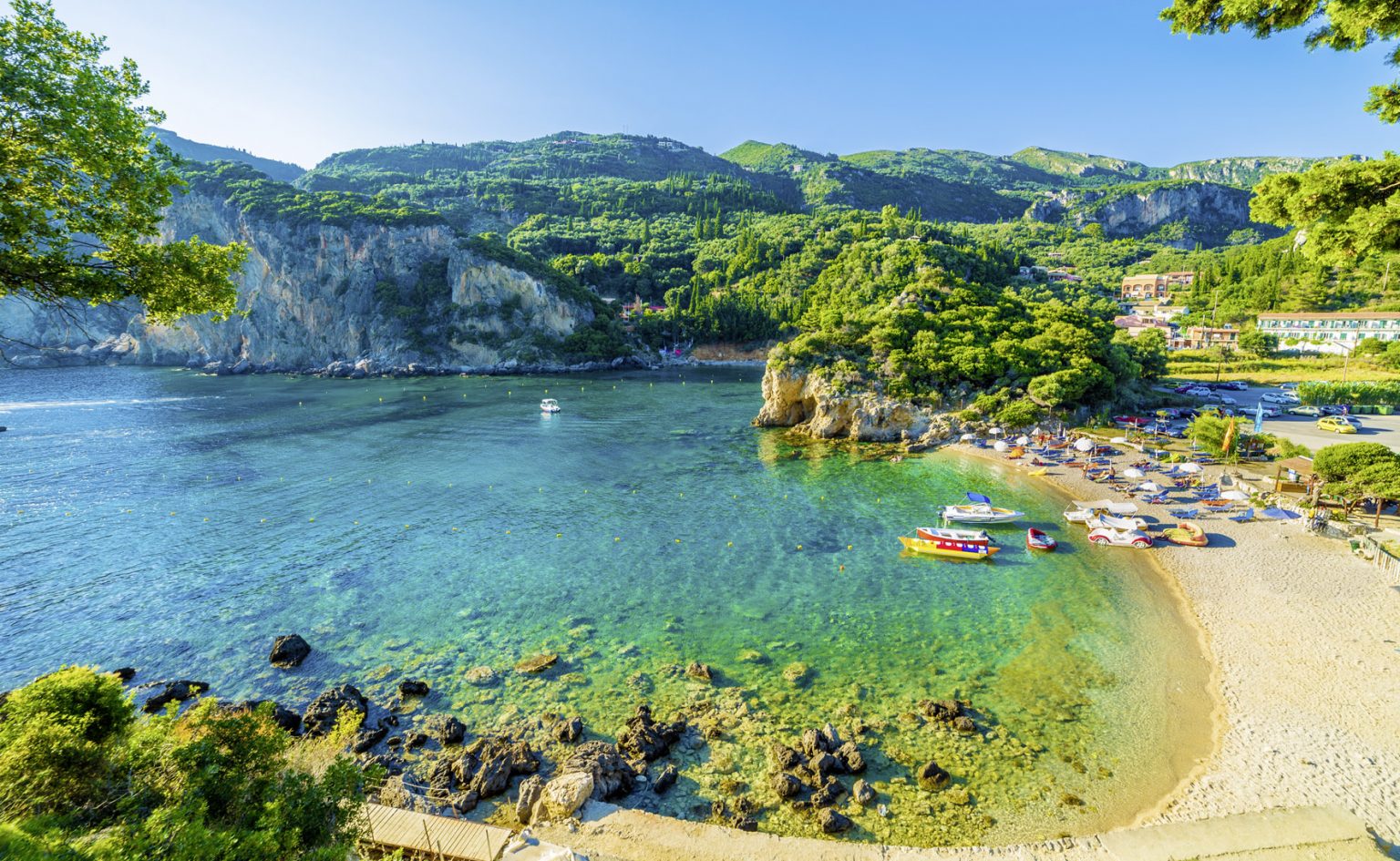 Beach and boat in Paleokastritsa, Corfu Reisehugo.de